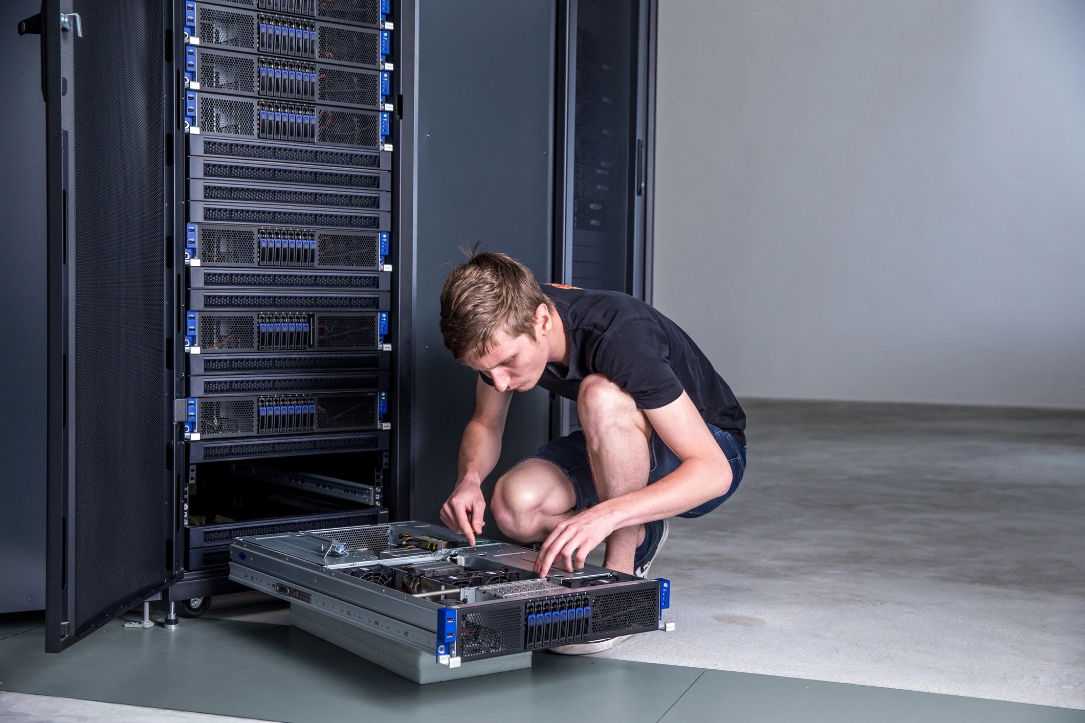 IT engineer servicing a supercomputer rack