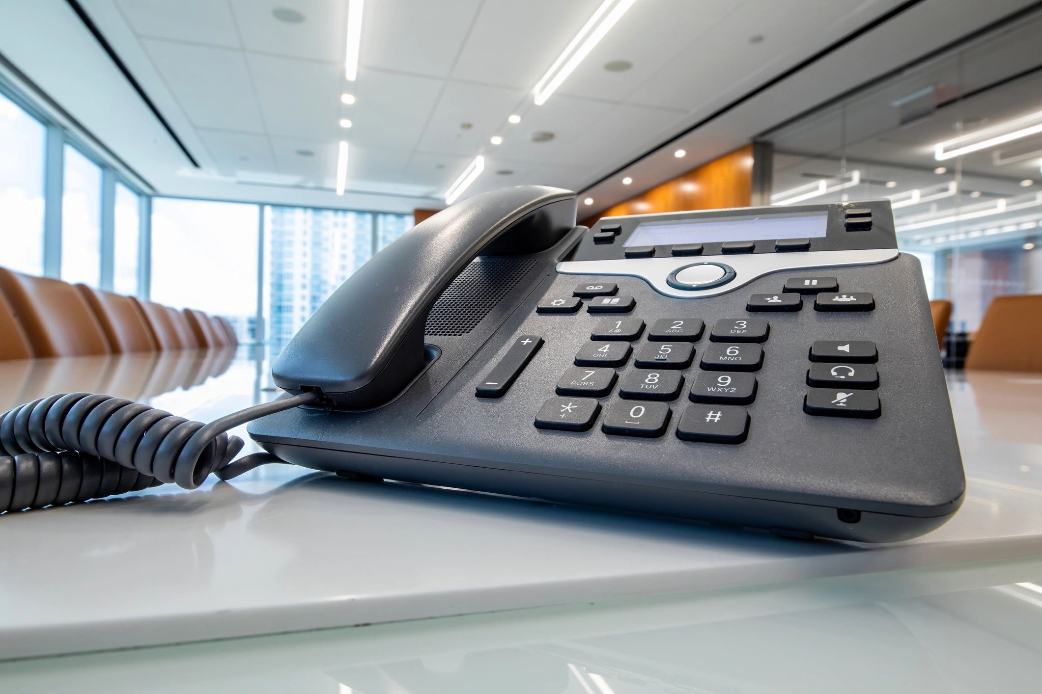 Desk phone in an office meeting room representing business VoIP